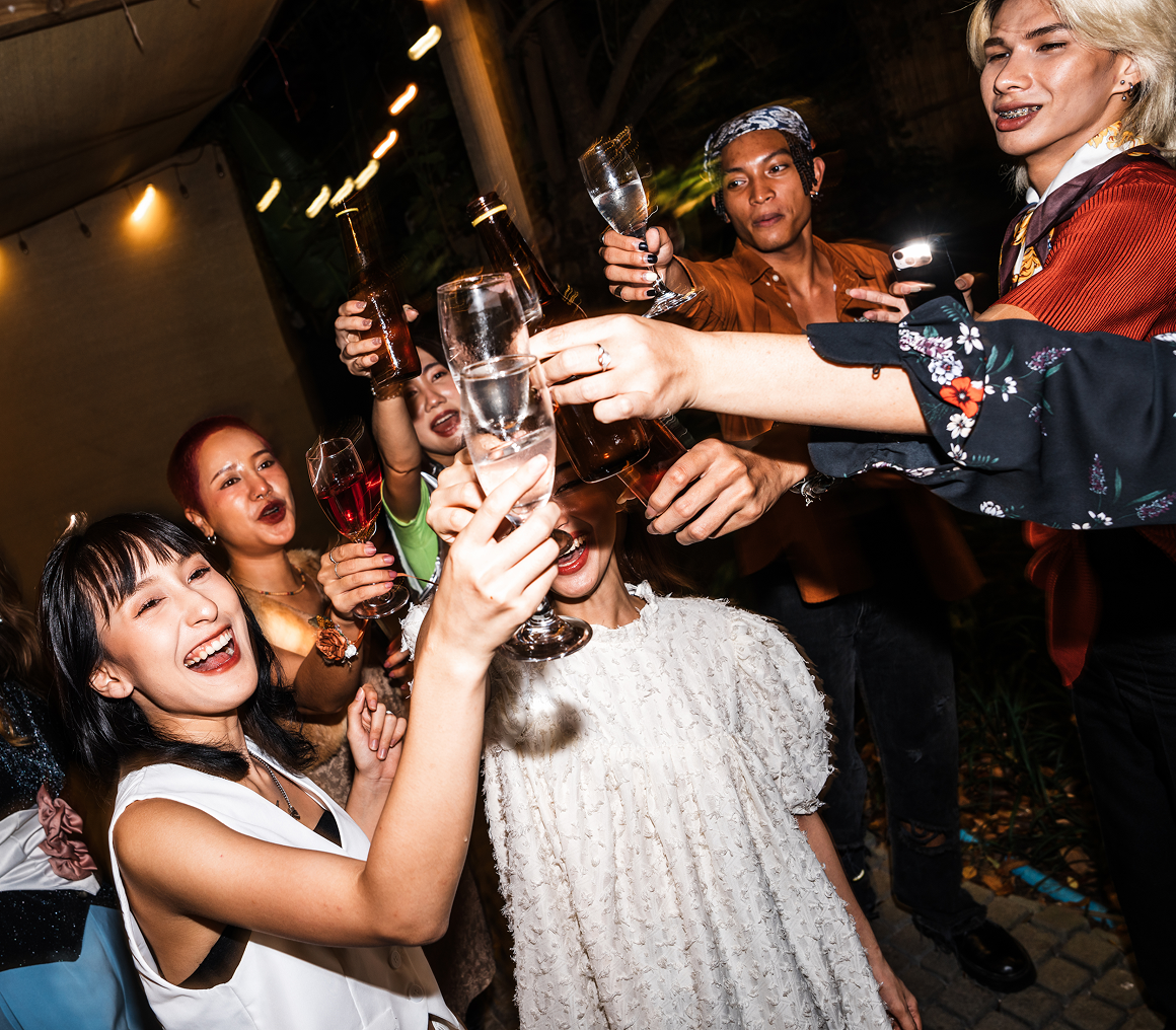 Friends cheerfully raising their drinks