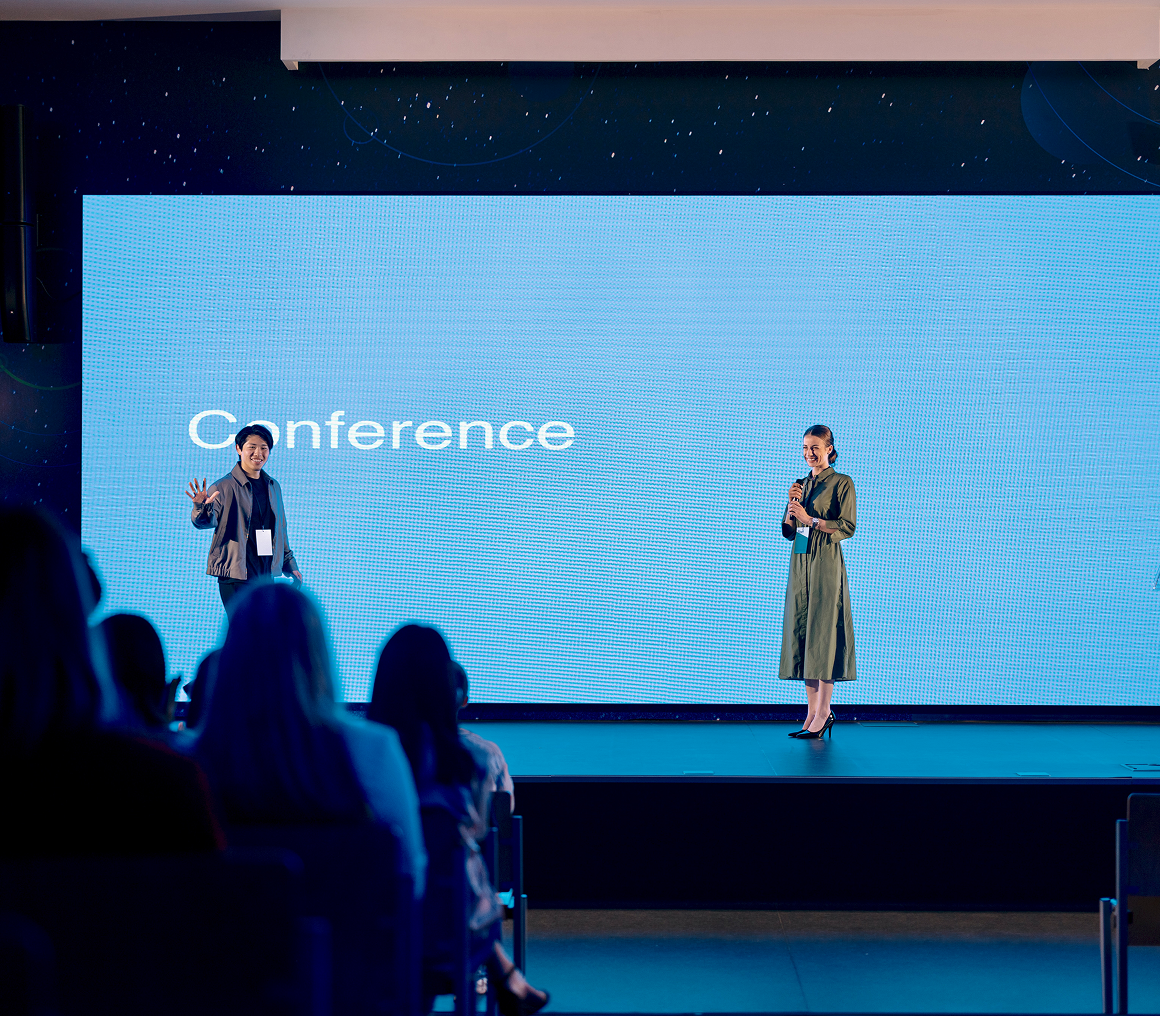 Presenters addressing an audience at event