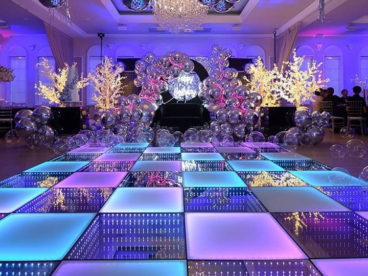 Illuminated dance floor with colorful decorations.