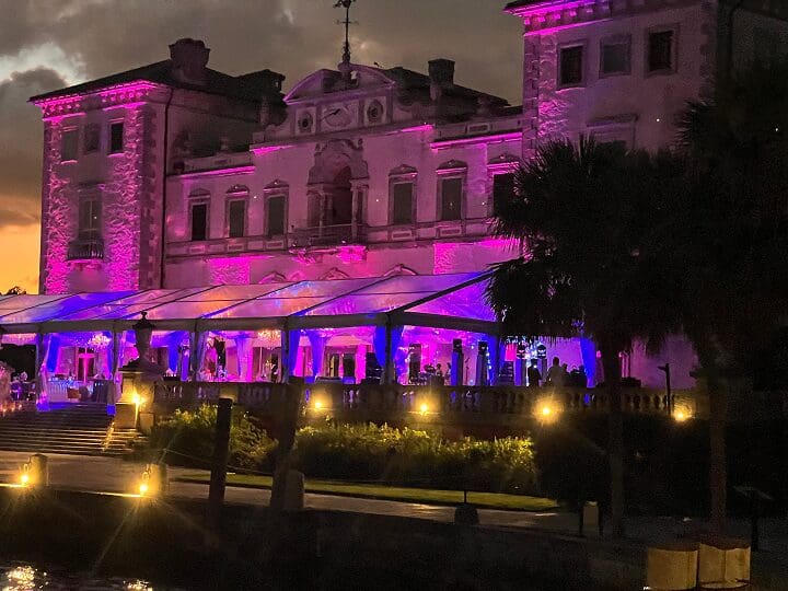 Illuminated venue with elegant purple lighting.