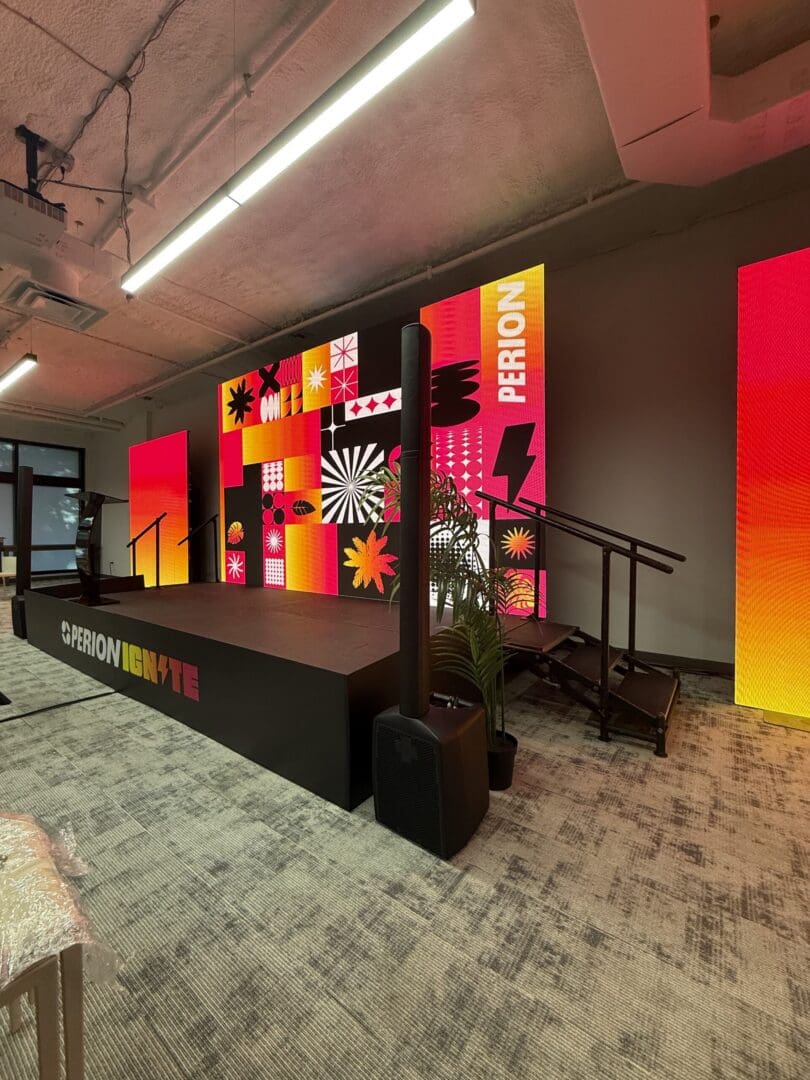 Colorful stage setup with vibrant digital displays.