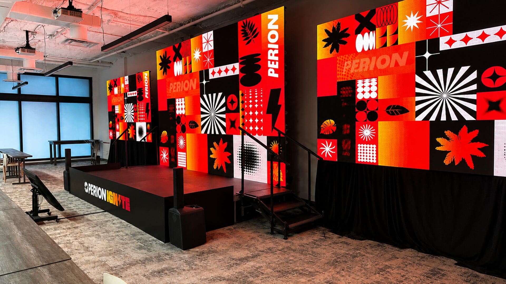 Colorful stage backdrop with dynamic visual elements.