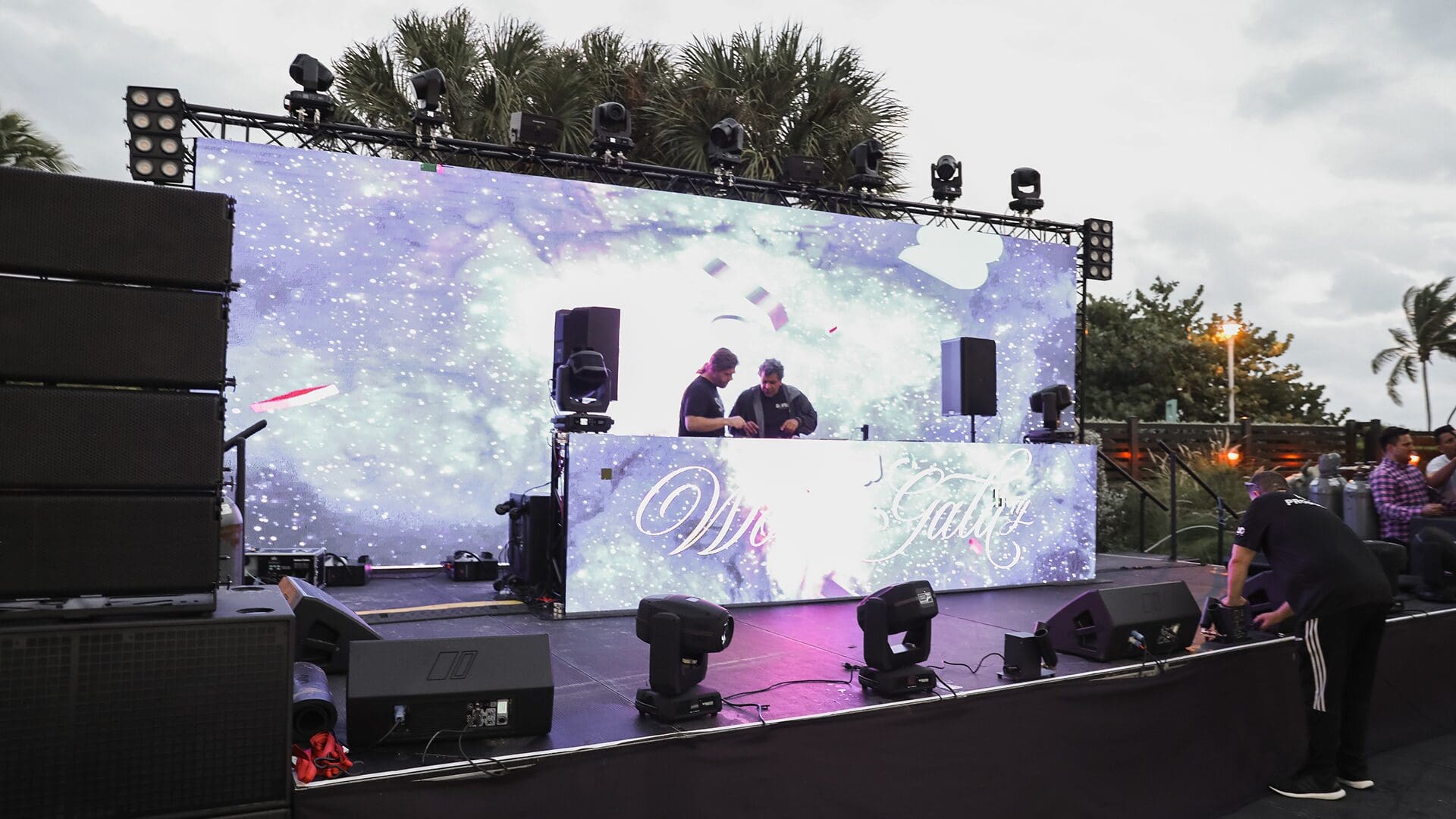 "DJ duo preparing for an outdoor performance."