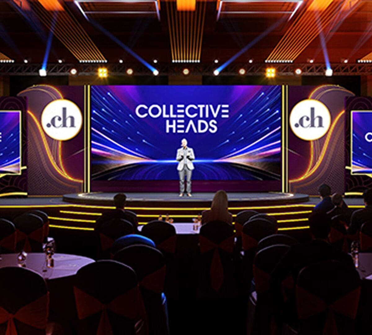 Speaker presenting on stage at an event.