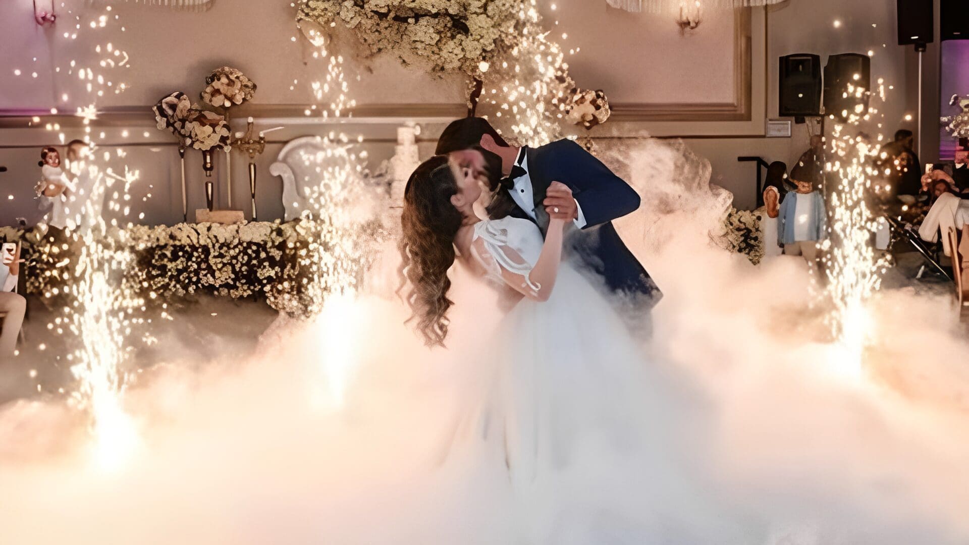 Couple sharing a romantic kiss with sparklers.